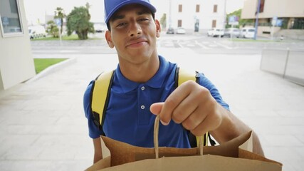 POV of african delivery man ringing doorbell holding paper bag for fast food deliver
