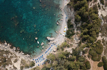Drone photo facing down the crystal clean rocky Greek bay