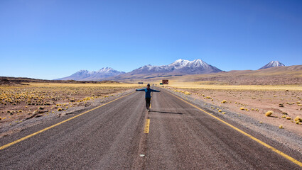 Tourist with the beautiful scenery and solitude on the high altiplano of the Atacama Desert, San Pedro de Atacama, Chile