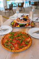 Italian pizza with herbs on a wooden table