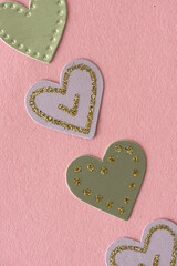 gold and lavender hearts on pink paper background