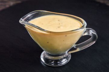 white cheese sauce in a gravy boat