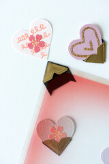 decorative paper hearts, retro gold tipped photo corners,  with plastic photo overlay on a light...