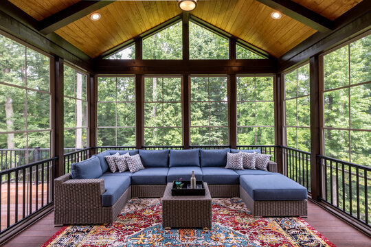 New Modern Screened Porch With Patio Furniture, Summertime Woods In The Background. New Home Addition Concept.