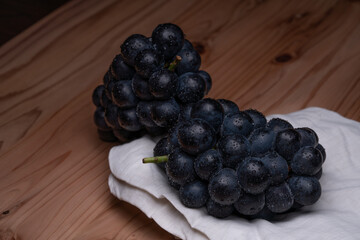 large grapes on a cloth on a black background.
A variety called Nagano Purple