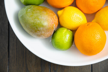 Assorted fruit in a white bowl.