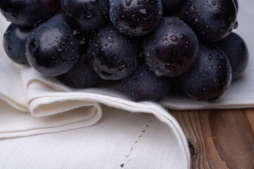 large grapes on a cloth on a black background.
A variety called Nagano Purple
