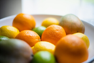 Assorted fruit in a white bowl.