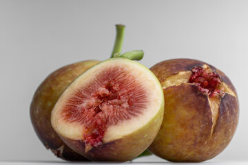 White background photo of figs cut in half.