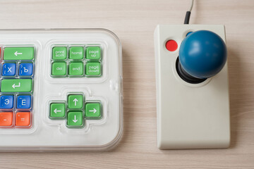 Close-up of a specialized computer mouse and keyboard for people with cerebral palsy.