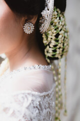 Beautiful Details of Javanese Bride in White Kebaya, Sanggul with Jasmine Flower Arrangements