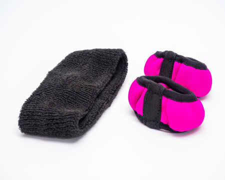 Pair of pink with black hand weights and headband to support hair for sports