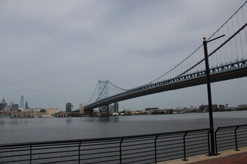 Fototapeta na wymiar Far shot of The Benjamin Franklin Bridge in Philadelphia during cloudy weather.
