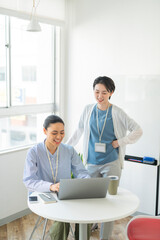 Obraz premium 先輩に業務を教わる女性