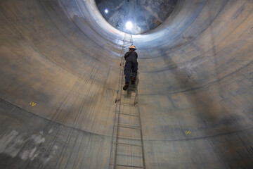 Male inside climb the stairway storage visual inspection tank