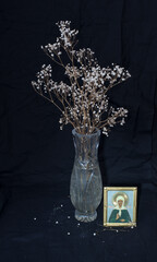 Icon of Matrona of Moscow and a vase with a dry twig