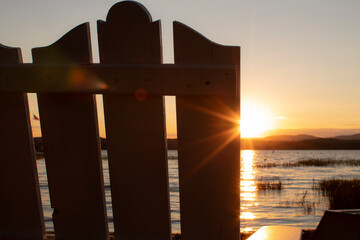adirondack chair overlooking lake sunset