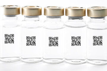 Proof of immunization, vaccination certificate and immunity pass concept with row of glass vials...