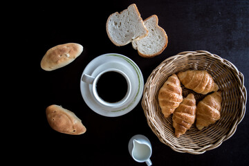 coffee with fresh croissants on wooden table