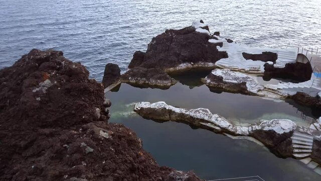 Natural And Empty Swimming Pool With Seascape During COVID-19 Pandemic In Doca do Cavacas, Funchal, Madeira Island, Portugal. - high angle