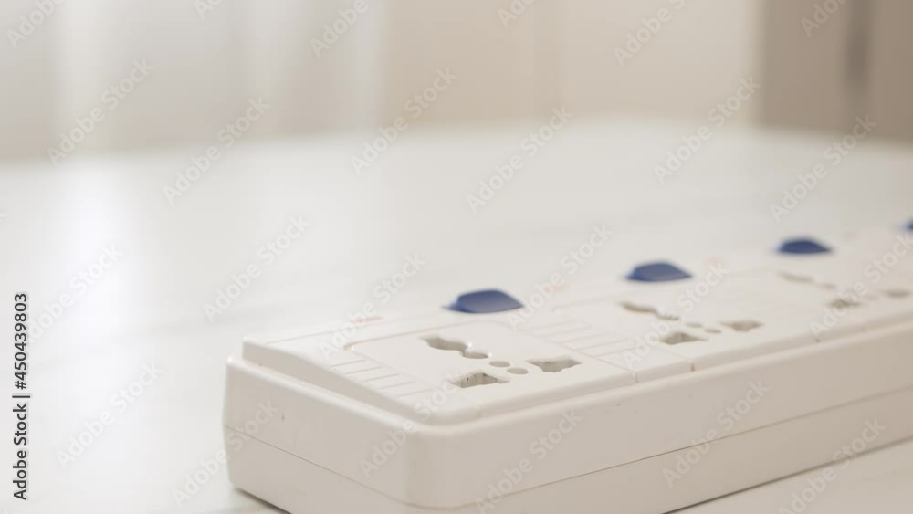 Poster close up man hand unplugging phone adapter battery and turn off the switch with removing the charger