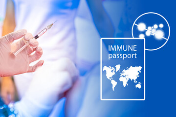 Obraz na płótnie Canvas Vaccination against coronavirus. A hand holds a syringe with a vaccine next to the immune passport. Development of immunity to the coronavirus. Immunity to Covid-19.