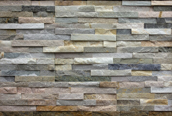 wall of natural stone blocks of gray and sand color