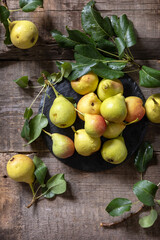 Organic healthy juicy ripe pear on a wooden kitchen table. The concept of Diet menu and harvesting fruits. Top view flat lay background. Copy space.