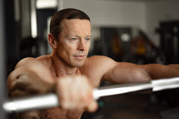 Portrait of a senior muscular man in a gym