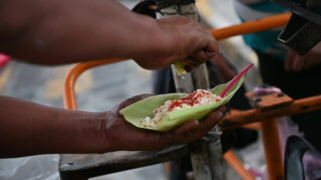 squeezing lemon to Mexican organic corn
