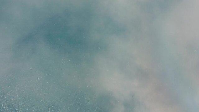 Panorama Of Feathery Clouds Under The Blue Ocean And The Green Landscape In Westfjords, Iceland. aerial