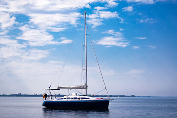 yacht on the water against the blue sky with clouds