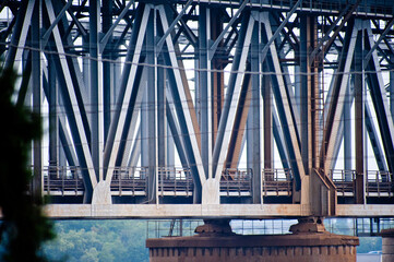 Large railway bridge with concrete supports over the river.