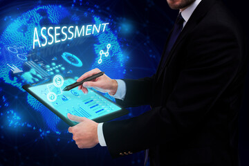 Business, Technology, Internet and network concept. Young businessman working on a virtual screen of the future and sees the inscription: Assessment