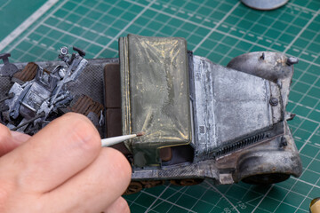 Scale Modeling. A man make mud and dust weathering on the roof of the military car cab. 1:35 Model...