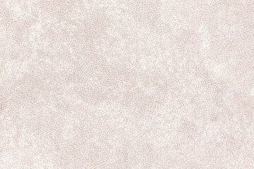 Fototapeta premium A pattern of mottled fabric with small spots. Light brown abstract blurred texture.