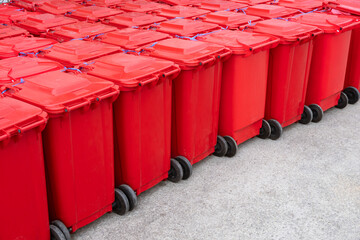 Rows of red hazardous waste bins are neatly packed with rubbish from COVID-19 patients behind the...