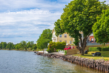 Idyllic view with houses by a lake in summer