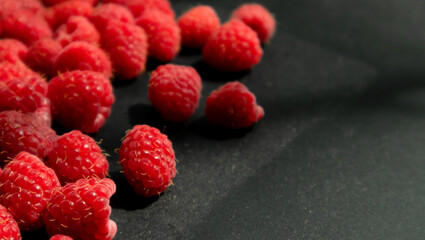 Fresh and sweet raspberry in a dark background. Selective focus.