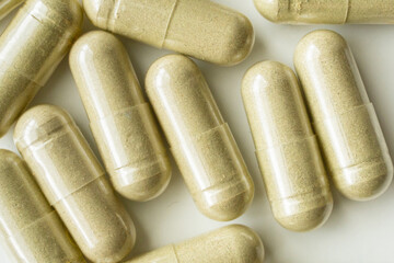 Herbal medicine capsules on white background