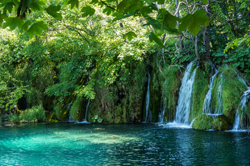 Waterfall with turquoise water in the Plitvice Lakes National Park, Croatia.