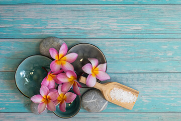 frangipani flowers as a spa concept with zen stones and small bowls - 450465006