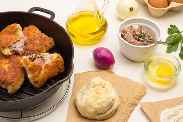Fried pies with meat in pan.