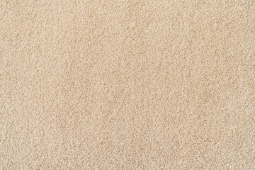 Fototapeta na wymiar Beige curly wool seamless texture background. texture with short factory material.