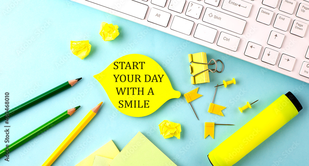 Aufkleber text sign showing start your day with a smile with office tools and keyboard on the blue background