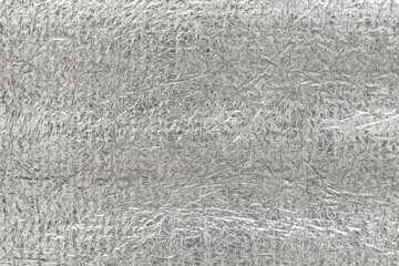 Seamless background texture of silver foil. shiny white surface. reflector