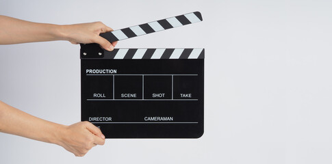 Hands is holding black Clapperboard or movie slate. it use in video production ,film, cinema industry on white background. - obrazy, fototapety, plakaty
