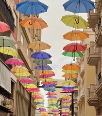 Fototapeta na wymiar Umbrellas at Commercial street. Motril. Granada. Andalusia. Spain