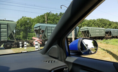 Closed Level Crossing With Moving Train View From Waiting Car