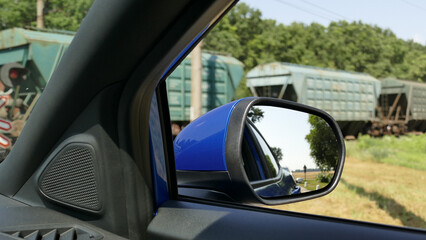 Car Waiting When Cargo Train Passes By Rail Crossing